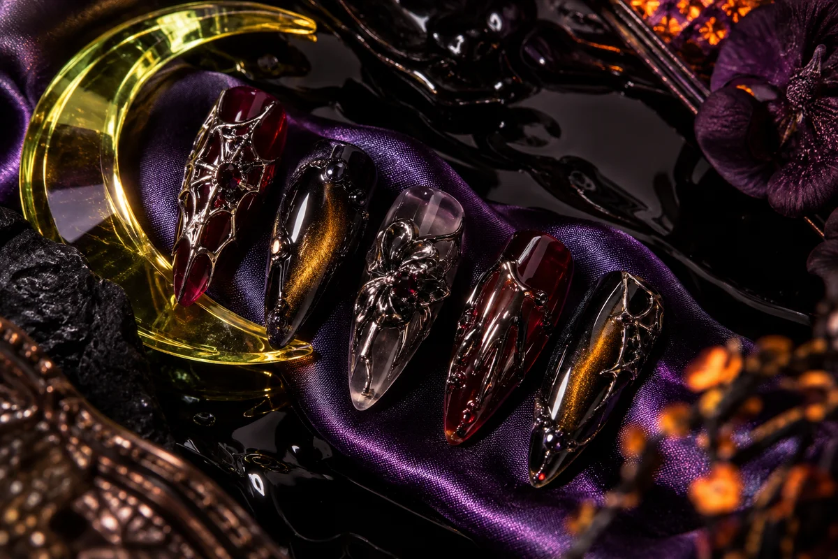 Halloween concept nail art with silver webs and dark crystals on violet silk